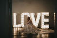Load image into Gallery viewer, Large 5ft light up letters displayed at a wedding venue, illuminated with warm white LED bulbs – perfect for creating standout photo moments.