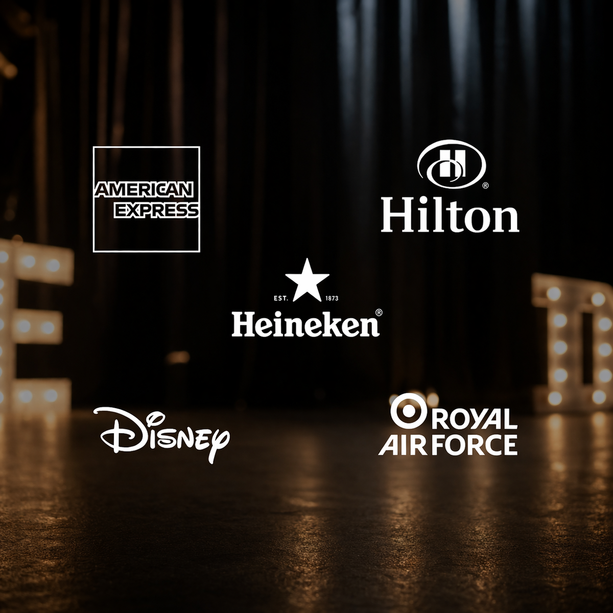 Logos of American Express, Hilton, Heineken, Disney, and Royal Air Force on a dark background.