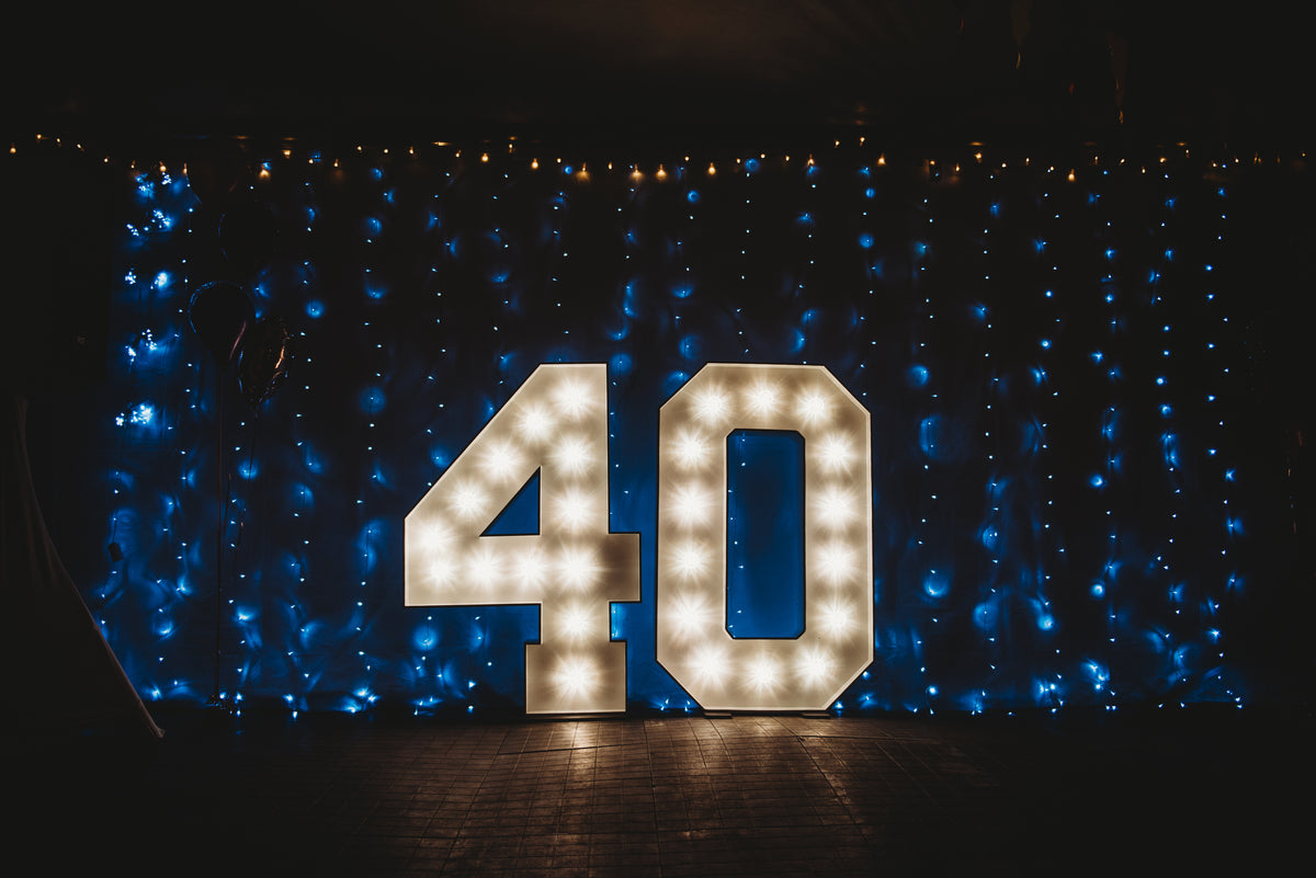 Light-up number '40' against a dark background with blue string lights