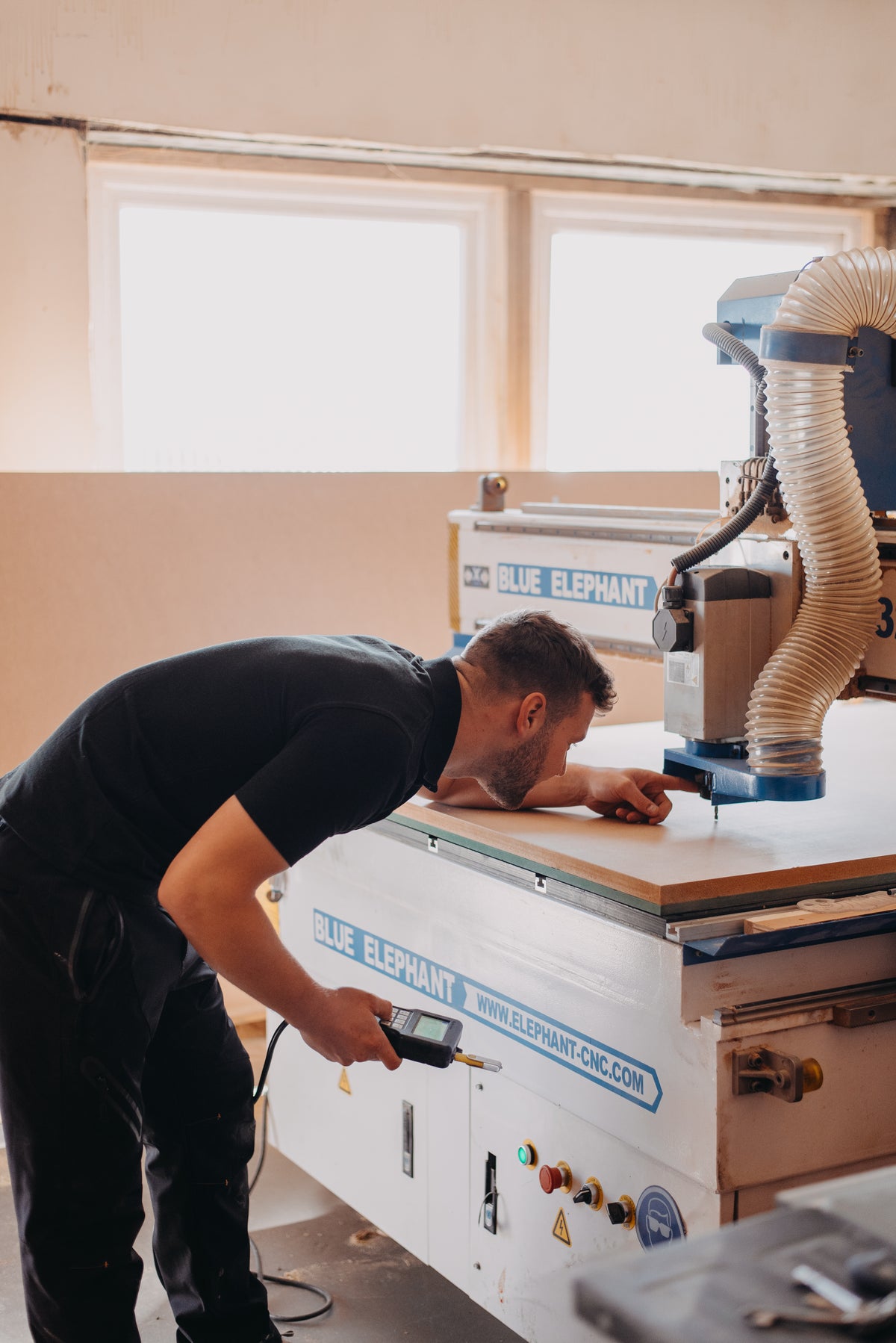 Man operating a CNC machine in a workshop