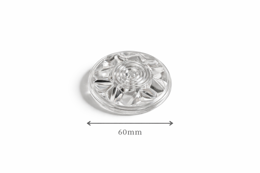 Clear plastic light cap component with measurement label on a white background