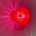 Load image into Gallery viewer, E14 neon pink cabochon cap and base set illuminated – showing vivid hot pink glow output for fairground and event lighting
